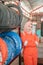 Close up of a woman in a veil wearing a wearpack uniform with crossed hands beside a tire rack