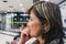 Close up on a woman waiting anxious on the airport`s departure l