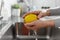 Close up of woman washing lemon fruit in kitchen
