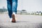 Close up woman wear jean and white sneaker walking forward on hi