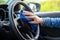 Close up woman wearing mask applying spray alcohol with microfiber cleaning interior car and steering wheel