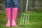 Close Up Of Woman Wearing Pink Wellingtons Holding Garden Fork