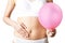 Close Up Of Woman Wearing Underwear Holding Pink Balloon And Touching Stomach