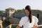 Close-up woman in a white blouse background of the defensive stone walls.