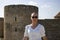 Close-up woman in a white blouse background of the defensive stone walls.