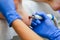 Close-up of a woman working with a special tool on her foot. Pedicure. The filing of calluses