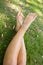 Close up of a womans crossed legs lying on the grass