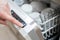 Close Up Of Womanâ€™s Hand Pressing Start Button On Dishwasher