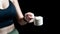 Close up of women hand holding measuring scoop of whey protein  preparing protein shake