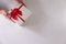Close-up women hands sending white gift box with red ribbon on white background