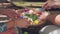 Close up of women making canang sari balinese offerings