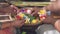 Close up of women making canang sari balinese offerings