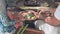 Close up of women making canang sari balinese offerings