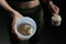 Close up of women with measuring scoop of whey protein, jar and shaker bottle, preparing protein shake