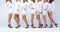 Close-Up of Women\\\'s Graceful Legs in White Shirts