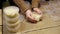 Close-up of women's hands making many bowls of rice porridge to feed people