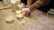 Close-up of women's hands making many bowls of rice porridge to feed people