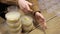 Close-up of women's hands making many bowls of rice porridge to feed people