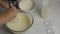 Close-up of women`s hands mixing flour in a transparent bowl with kefir and eggs