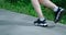 Close up of womens legs running on asphalt road