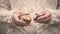 Close up of womenâ€™s hands holding opening spiky wild horse chestnut