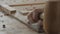 Close-up. a woodcarver processes a walnut wood board with a chisel and mallet. craftsman makes a tea tray