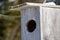 Close-up of a Wooden Birdhouse's Circle Entrance