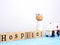 Close up wooden blocks wording Hospital and small white ambulance model on blue wood background