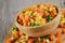 Close up of a wooden bowl of delicious mixed vegetables