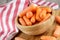 Close up of wooden bowl filled with delicious Baby Carrots