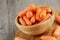 Close up of wooden bowl filled with delicious Baby Carrots