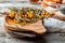 Close up. Wooden bowl with sprigs of bright yellow sea buckthorn berries. Rustic wooden background