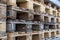 Close up of wooden cargo pallets overlap in warehouse. Selectiive focus