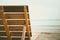 Close up of wooden chair backrest on the sandy beach