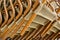 Close Up of wooden chairs, wicker-backed chairs stacked in a pile. Abstraction