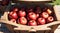 a close up of a wooden crate filled with red apples