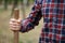 A close-up of a wooden handle of shovel in the male hand. A man body with a shovel on a natural background. Ecology