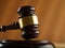 Close-up. Wooden judge`s gavel on a beige background. Court, justice, presumption of innocence, Constitution, rule of law, auctio