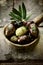 Close-up of a wooden ladle with seasoned olives