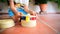 Close-up of a wooden montessori toy while a child play with him to develop his dexterity, defocused 2