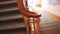 Close up of wooden old fashioned railings and staircase inside a house. Stock footage. Top view of granite stairs in the
