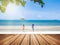 Close up wooden plank with blurred background of sea view with boys and girls running into the sea