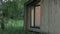 Close-up wooden scandinavian house the light is on in the window, forest cabin in the middle of a forest in silence