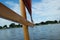 Close up of the wooden spar boom on a small sailing dinghy with a red sail