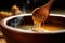 close-up of wooden spoon stirring steaming soup