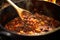 close-up of wooden spoon stirring stew in dutch oven