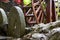 Close-up of wooden waterwheel and millstone in the countryside