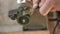 Close-up. a worker grinds a homemade chisel from a bearing using goi paste. making a chisel from a bearing