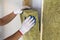 Close-up of worker hands in white gloves insulating rock wool insulation staff in wooden frame for future walls for cold barrier.