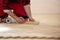 Close up of worker installing wood parquet. Worker laying parquet flooring. Worker installing wooden laminate flooring